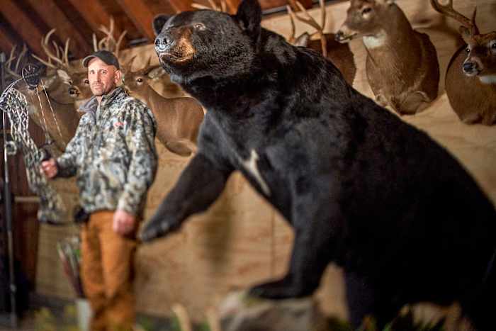 Melillo at home with his stuffed, record bear.